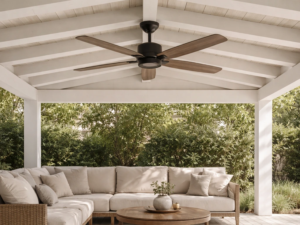 Ceiling fan mounted under a covered patio roof above a shaded outdoor seating area